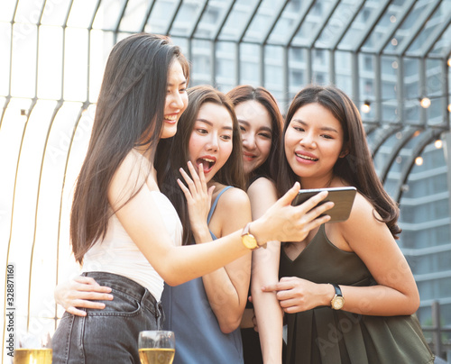 group asian party woman looking at phone and laugh