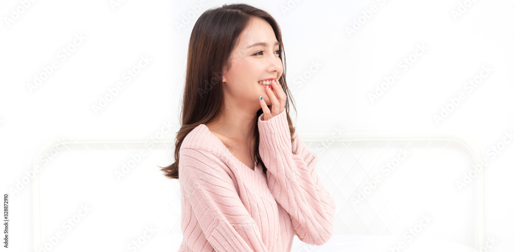 Smiling of cheerful beautiful pretty asian woman clean fresh healthy white skin posing in warm knitted pink clothes.Girl felling relaxing and enjoy time on the bed at home.asia beauty Smiling of cheerful beautiful pretty asian woman clean fresh healthy white skin posing in warm knitted pink clothes.Girl felling relaxing and enjoy time on the bed at home.asia beauty