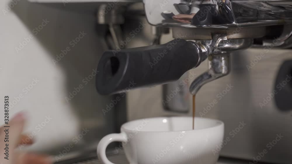 Making cappuccino. Pouring coffee from a coffee machine into a cup. Slow motion Making cappuccino. Pouring coffee from a coffee machine into a cup. Slow motion