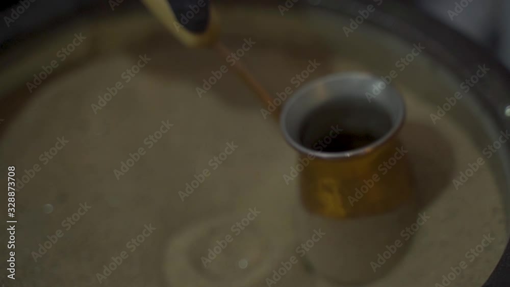 Make coffee in the sand. Slow motion