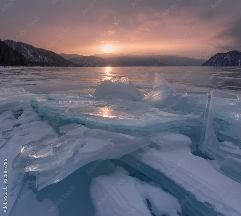 Nature Of Russia, Siberian Landscape: Frozen Blue Ice Of The Teletskoye Lake, Shot At Sunrise. Nature Of Siberia. One Of The Attractions Of Altai Mountains, Popular With Tourists And Photographers