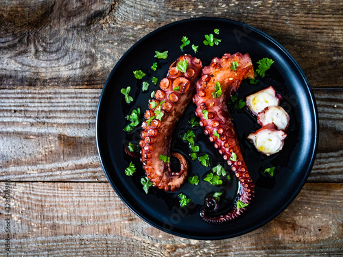 Barbecue octopus on wooden table photo