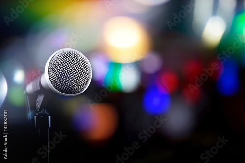 Microphone on a black background with colorful lights and flares