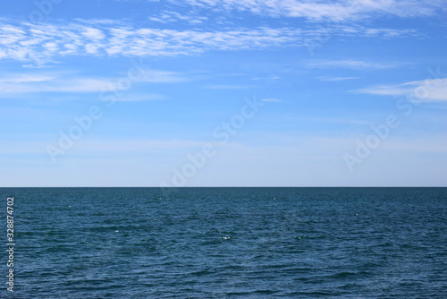 Beautiful view of the calm sea. Blue water surface with small waves in calm. View of the endless sea. Horizon in the sea. © Светлана Тырышкина