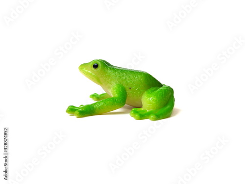 Close up of green frog toy isolated on white background. Artificial frog. Kids toy. Rubber toy.