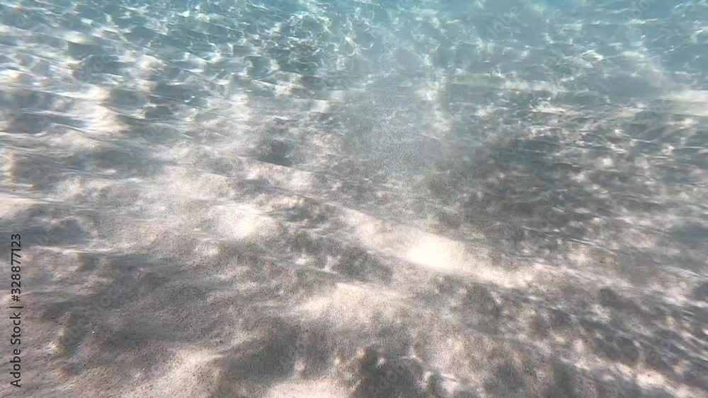 Clear water. underwater background with sandy sea bottom. Natural texture Clear water. underwater background with sandy sea bottom. Natural texture