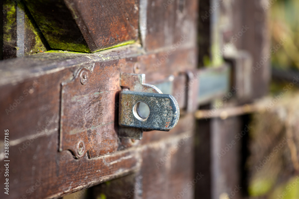 Detail of fittings of old brown garden wooden doors Detail of fittings of old brown garden wooden doors