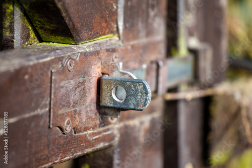 Detail of fittings of old brown garden wooden doors
