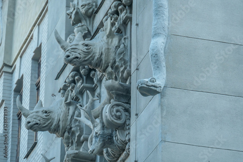 A close up on rhinos on the side wall of House with Chimaeras/Horodecki House build in Art Nouveau style in Kiev, Ukraine. House is decorated with various animals like snakes, frogs, deer, elephants photo