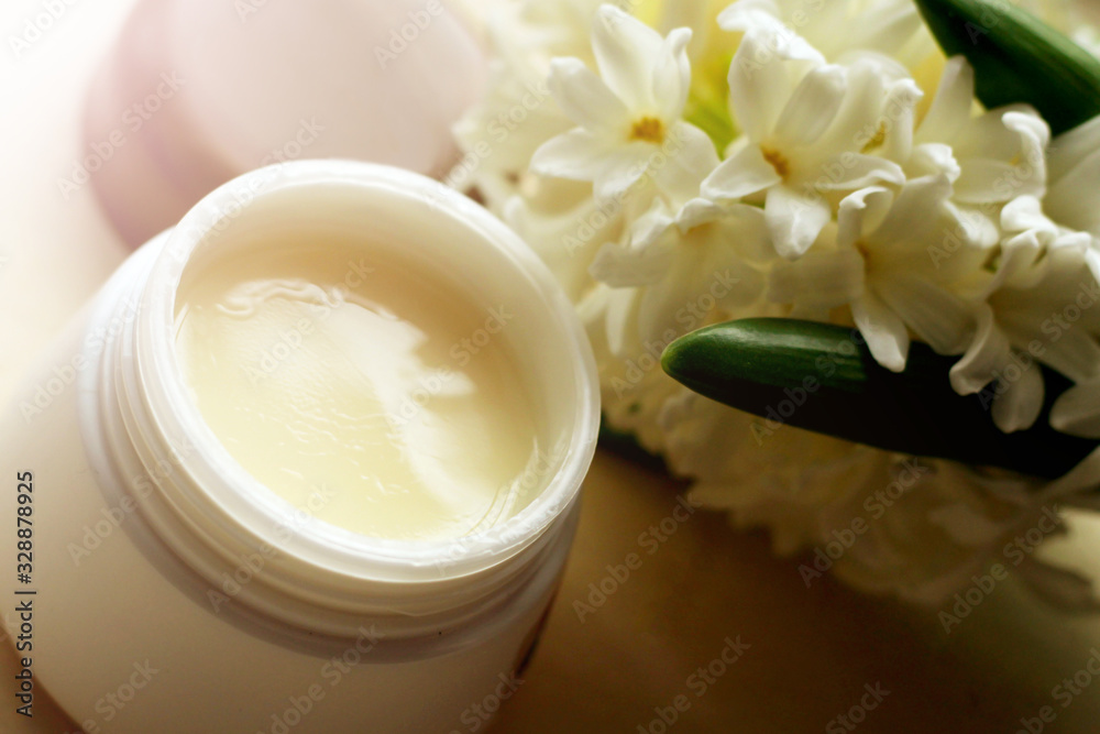 Face cream and white spring flowers Face cream and white spring flowers