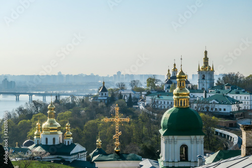 Green and golden rooftops of Pechersk Lavra Monastery, known as Kiev Monastery of the Caves, located at the shore of Dnieper. Historic Orthodox Christian monastery. Splendid, glamorous looking church photo