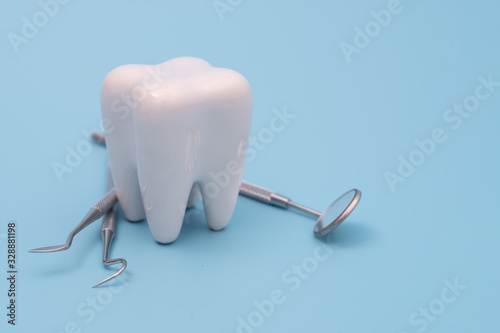 Teeth model and dentist tool on blue © onairjiw
