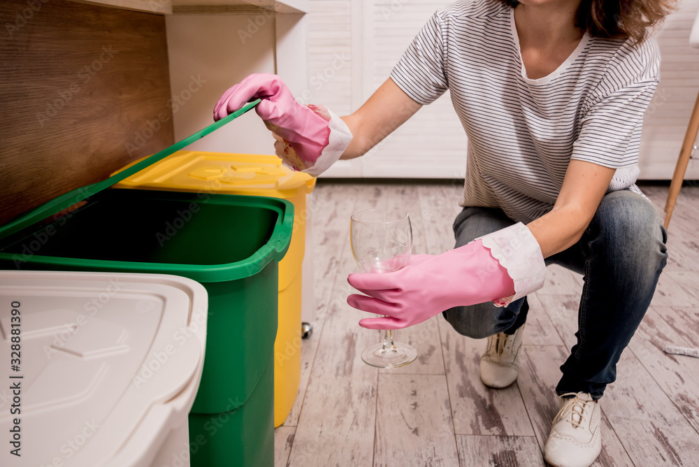Young girl sorting garbage at the kitchen. Concept of recycling. Zero waste Young girl sorting garbage at the kitchen. Concept of recycling. Zero waste