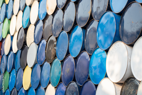 used metal chemical containers. Old steel barrels stacked in recycle factory yard.