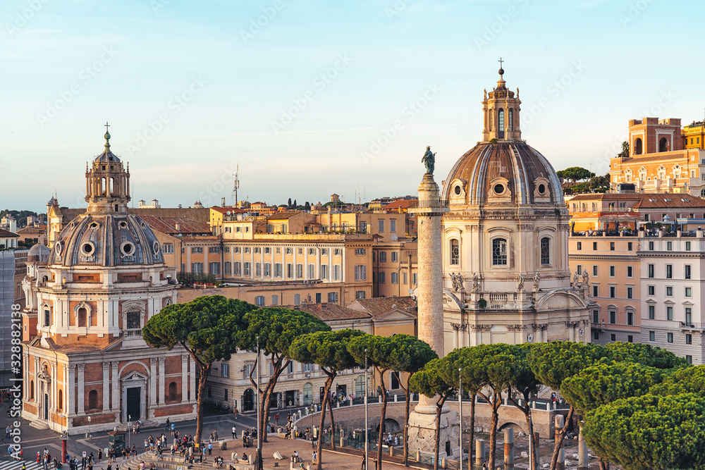 Aerial view of domes of Santa Maria di Loreto church at sunset in Venice Square in Rome, Italy.