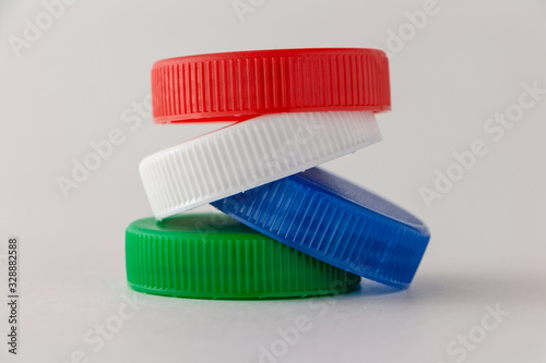 A stack of four colored plastic caps.