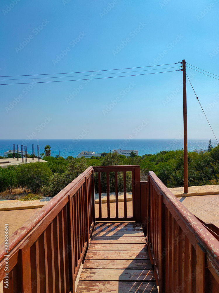 View to the Mediterranean sea from wooden stairs in Cyprus