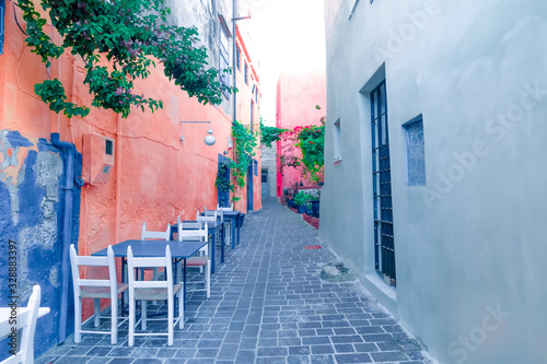 Cafe and restaurants at amazing narrow streets of popular destination on Crete island. Greece. Traditional architecture and colors of mediterranean city. Place for romantic vacation and summer travel © PerfectLazybones