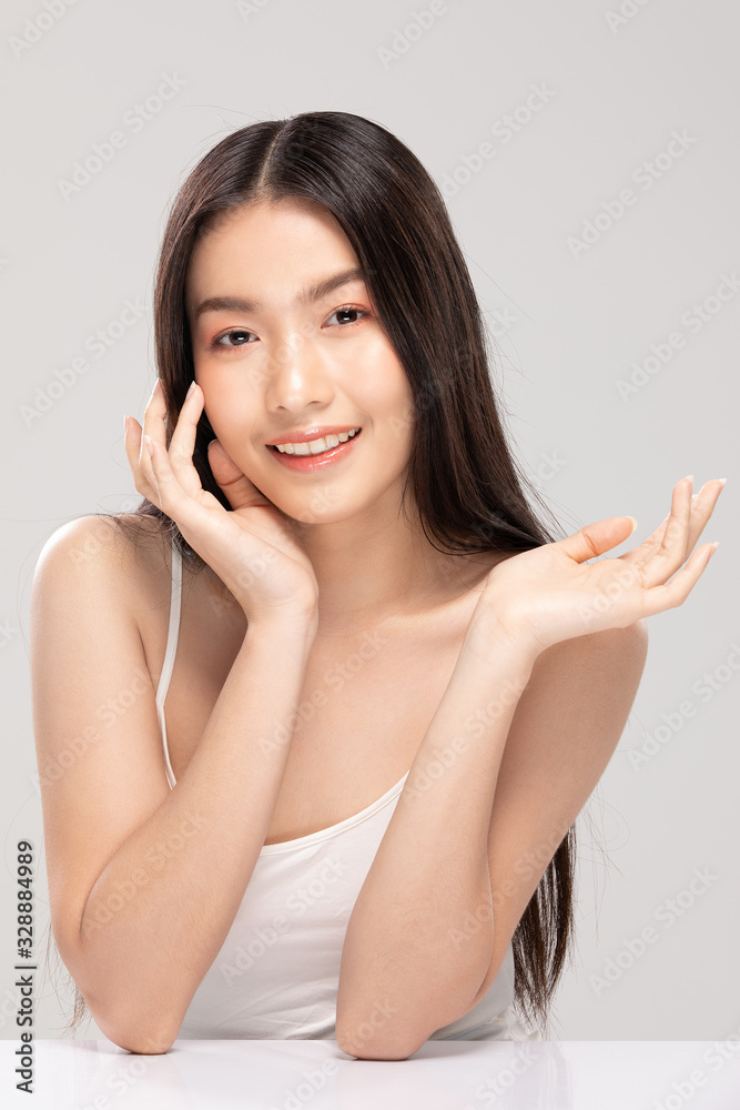Beautiful Asian young woman touching soft cheek smile with clean fresh skin Happiness and cheerful with positive emotional,isolated on white background,Beauty Cosmetics and Facial treatment Concept