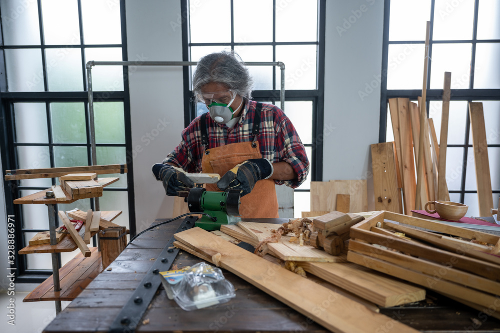 Carpenter working on woodworking machines in carpentry shop, wooden product Carpenter working on woodworking machines in carpentry shop, wooden product