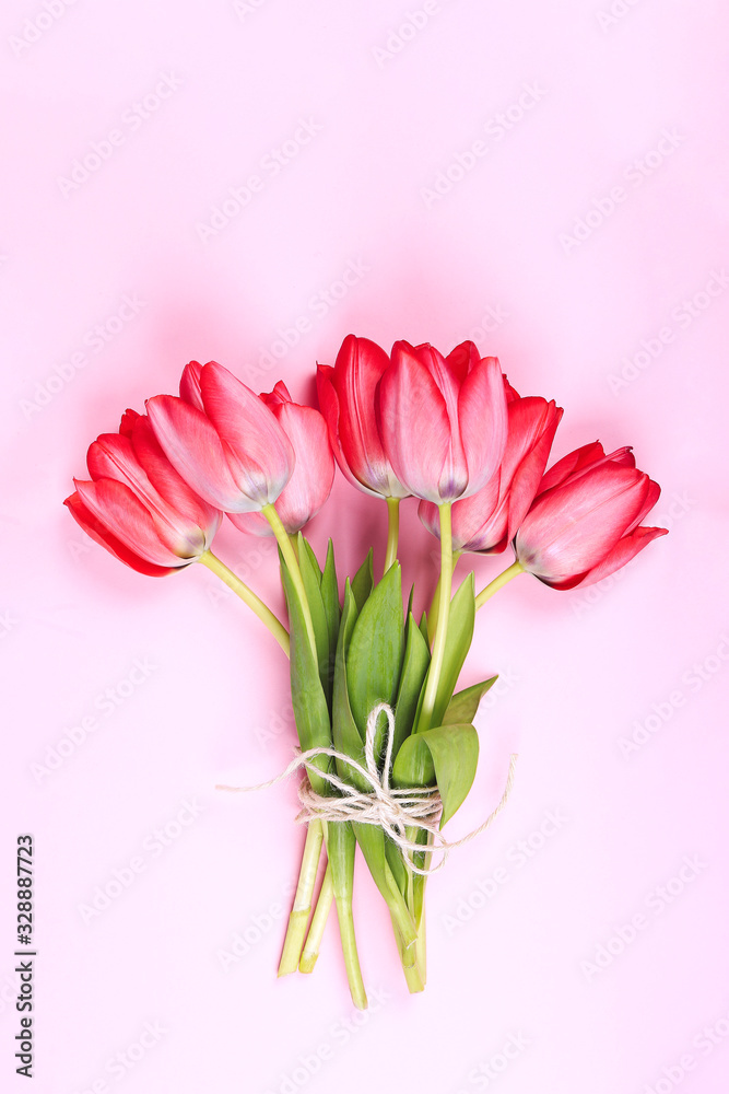 Fototapeta premium Bouquet of Pink Tulips and ribbon. Easter day background.
