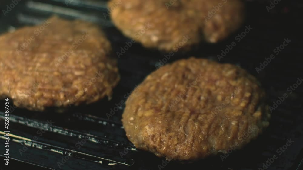 Some patties of ground meat with smoke and burgers juice sauce roasting, on cooking grill, Top View.