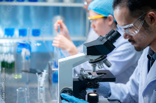 Researcher team and the development of antiretroviral drugs in a chemical laboratory photo