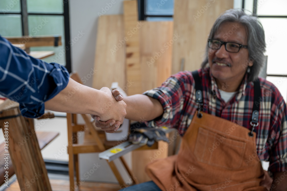 Two carpenters holding hands, The concept of working together until success