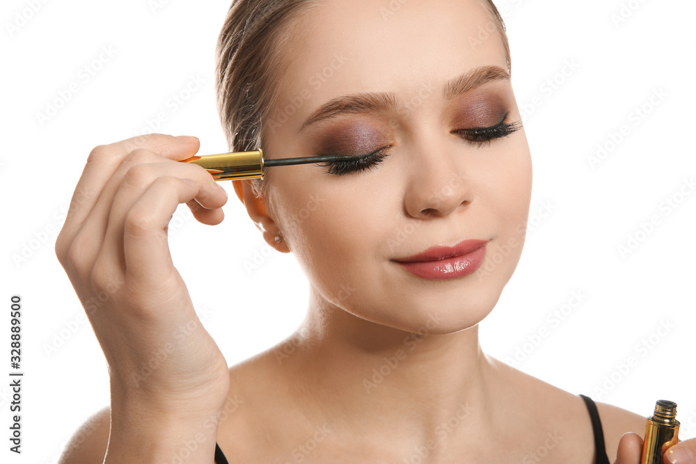 Beautiful woman applying eyeliner on white background. Stylish makeup Beautiful woman applying eyeliner on white background. Stylish makeup