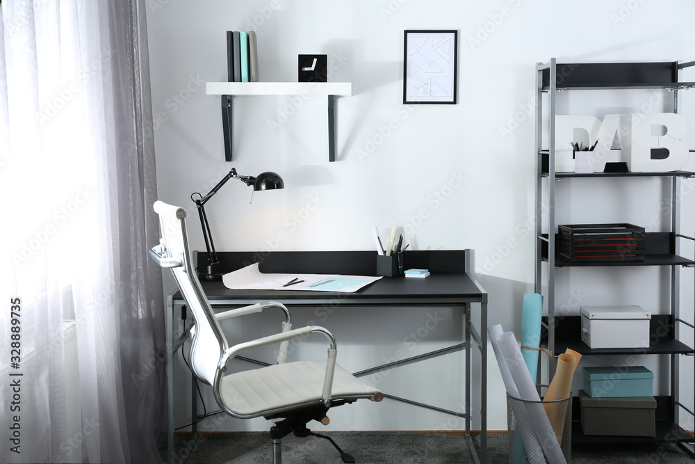 Stylish room interior with comfortable workplace near window. Design idea