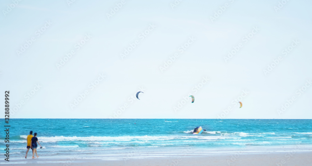 beach front landscape with motion blur people activity on sea and wind surf background in travel holiday concept