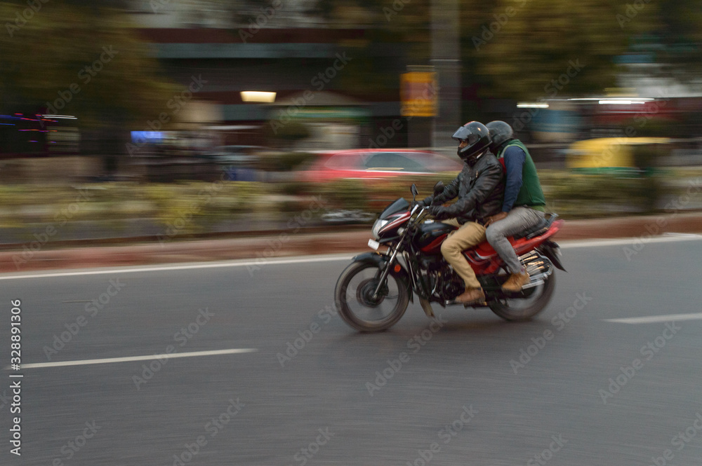 panning technique of red and black bike going somewhere at evening on the road panning technique of red and black bike going somewhere at evening on the road