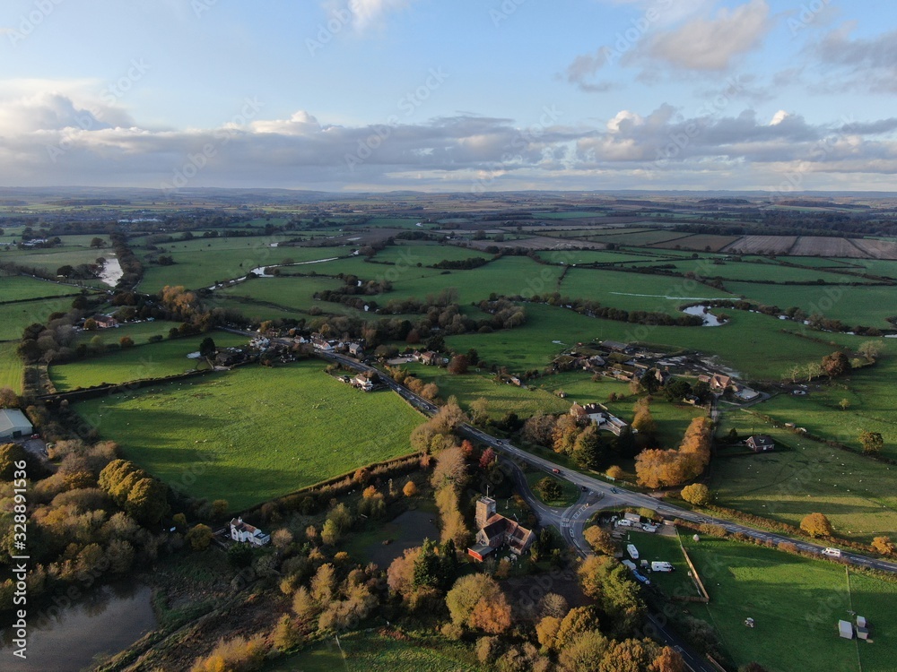 aerial view of Saint Huberts church in Corfe Mullen , Dorset looking over the fields and rolling landscape towards the North