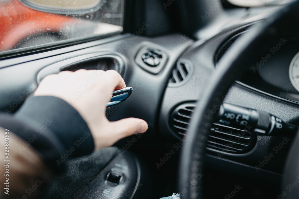 driver opens the car door from the inside, leather upholstery.