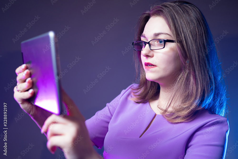Girl with a tablet in her hands. Concept - businesswoman. A woma