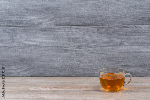 Mug of tea on the table and a background of wooden boards.