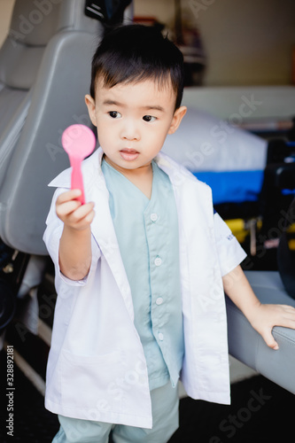 Asian little boy in a doctor suit in Ambulance
