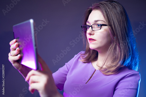 Girl with a tablet in her h...