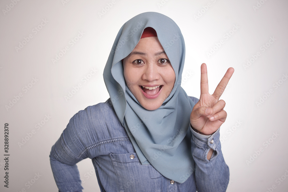Muslim Woman Smiling and Shows Number Two or Peace Sign Gesture Muslim Woman Smiling and Shows Number Two or Peace Sign Gesture