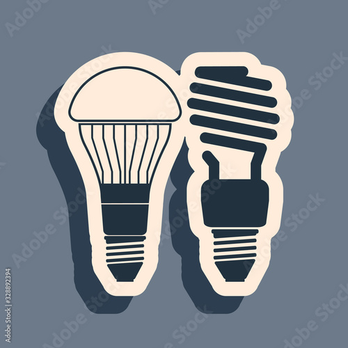 Black Economical LED illuminated lightbulb and fluorescent light bulb icon isolated on grey background. Save energy lamp. Long shadow style. Vector Illustration