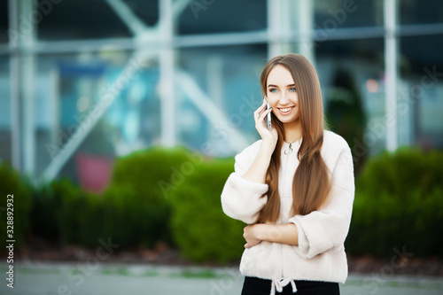 Business woman sitting on street near business center