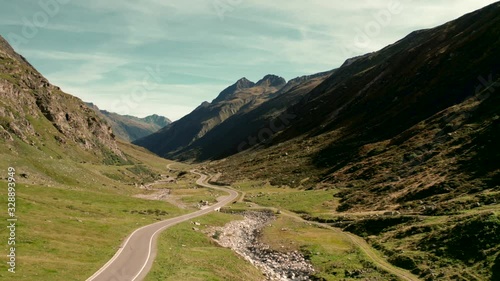 Empty road in the midst of a green Austria mountain valley photo