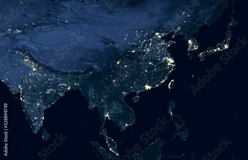 Earth at night, world map on satellite photo. City lights showing human activity in India, China, South Korea and Japan from space. Elements of this image furnished by NASA.