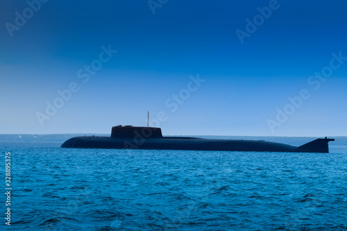 Military submarine. Submarine during ascent. Military submarine without identification marks. Naval forces. Concept - shipbuilding. Water weapon. The ship sank under water. Ascent. © Grispb