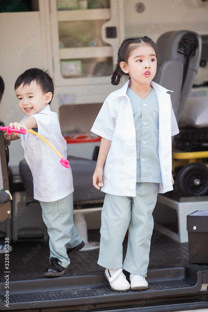 Asian little boy and girl in a doctor suit in Ambulance Asian little boy and girl in a doctor suit in Ambulance