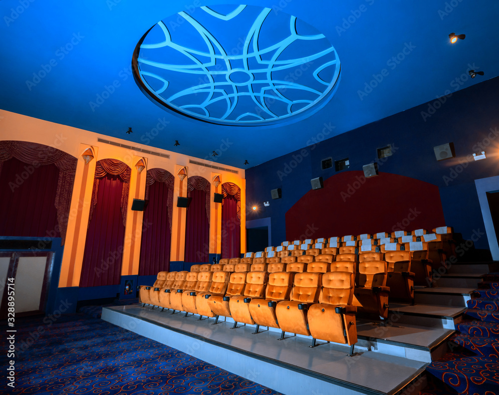 Large cinema theater interior with seat rows for audience to sit in ...