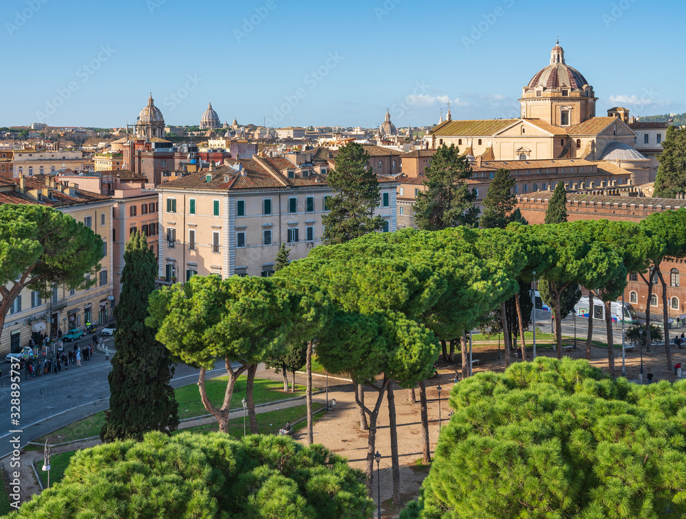 view to green pines and architecture of Rome in Italy