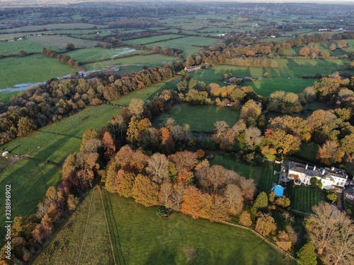 aerial view of countryside near Corfe Mullen , Dorset looking over the fields and forest with a white house in view