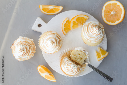 Lemon cupcakes with Italian meringue. Delicious homemade cakes. Top view, close- up, copy space.