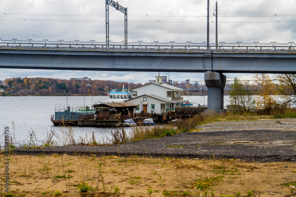 Boat station on the banks of the Volga river. River bridge.